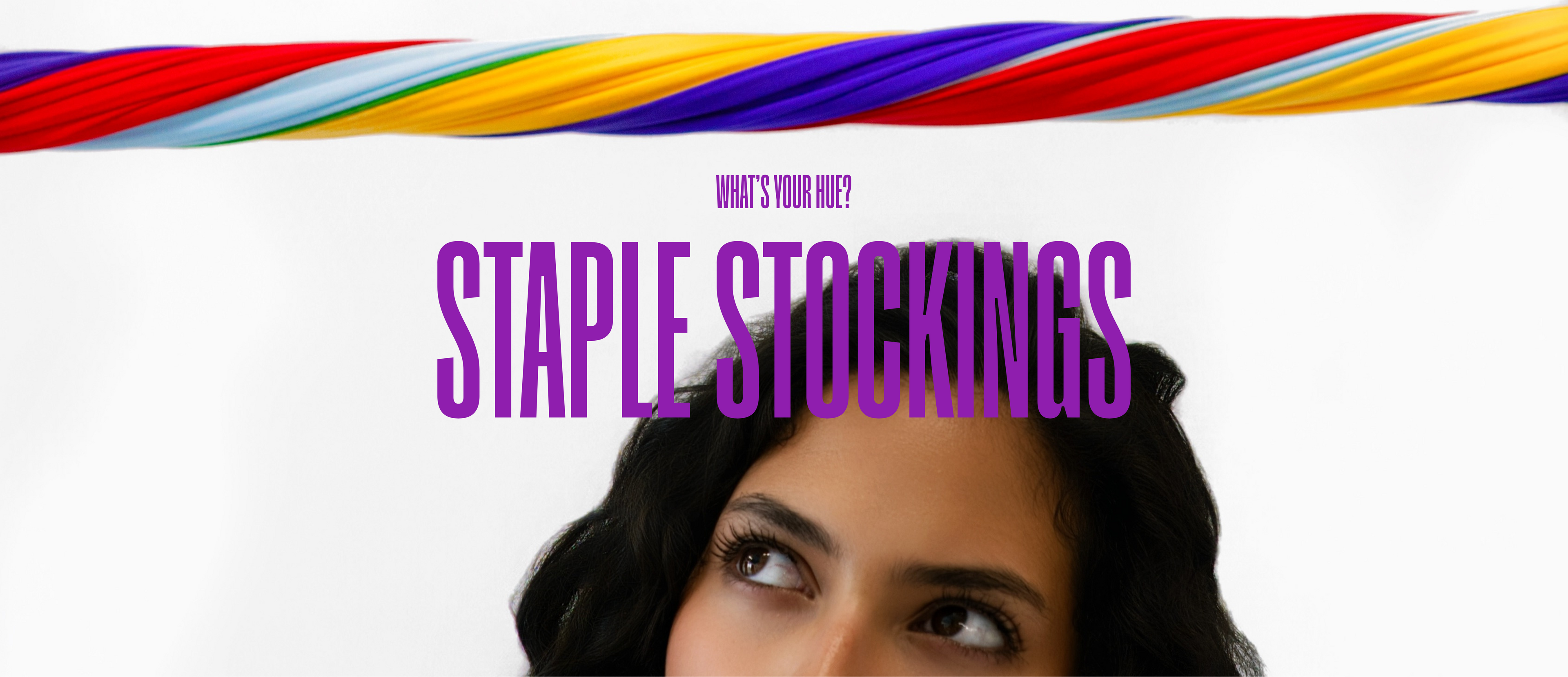 A promotional graphic for 'Staple Stockings' featuring a colorful striped ribbon across the top, purple text reading 'STAPLE STOCKINGS' and 'WHAT'S YOUR RIDE?' on a white background, with part of a woman's face visible at the bottom.